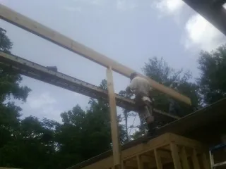 Carpenter setting a ridge beam over a new addition frame — Ice Dam Removal by Roofing Brothers in Absecon