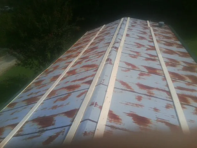 Rusted metal roof panels with new wood purlins before replacement — Storm Damage Roof Repair in Absecon by Roofing Brothers